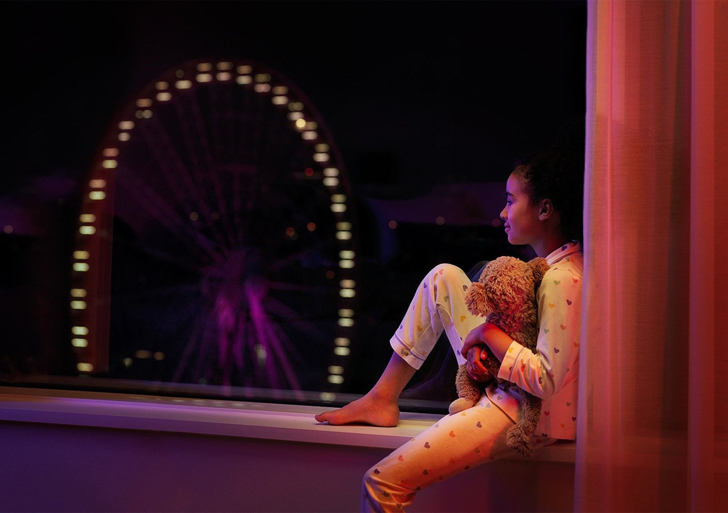 Girl in window with view over Liseberg