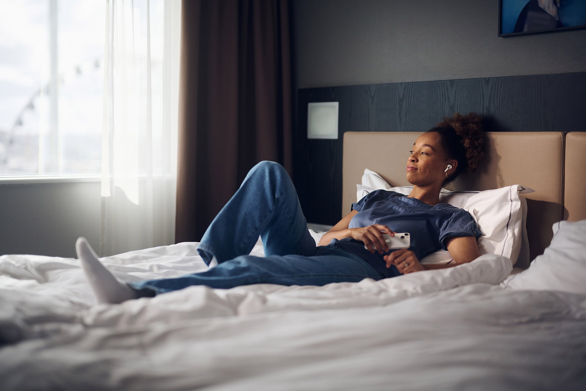 Youth in bed listening to music at Gothia Towers
